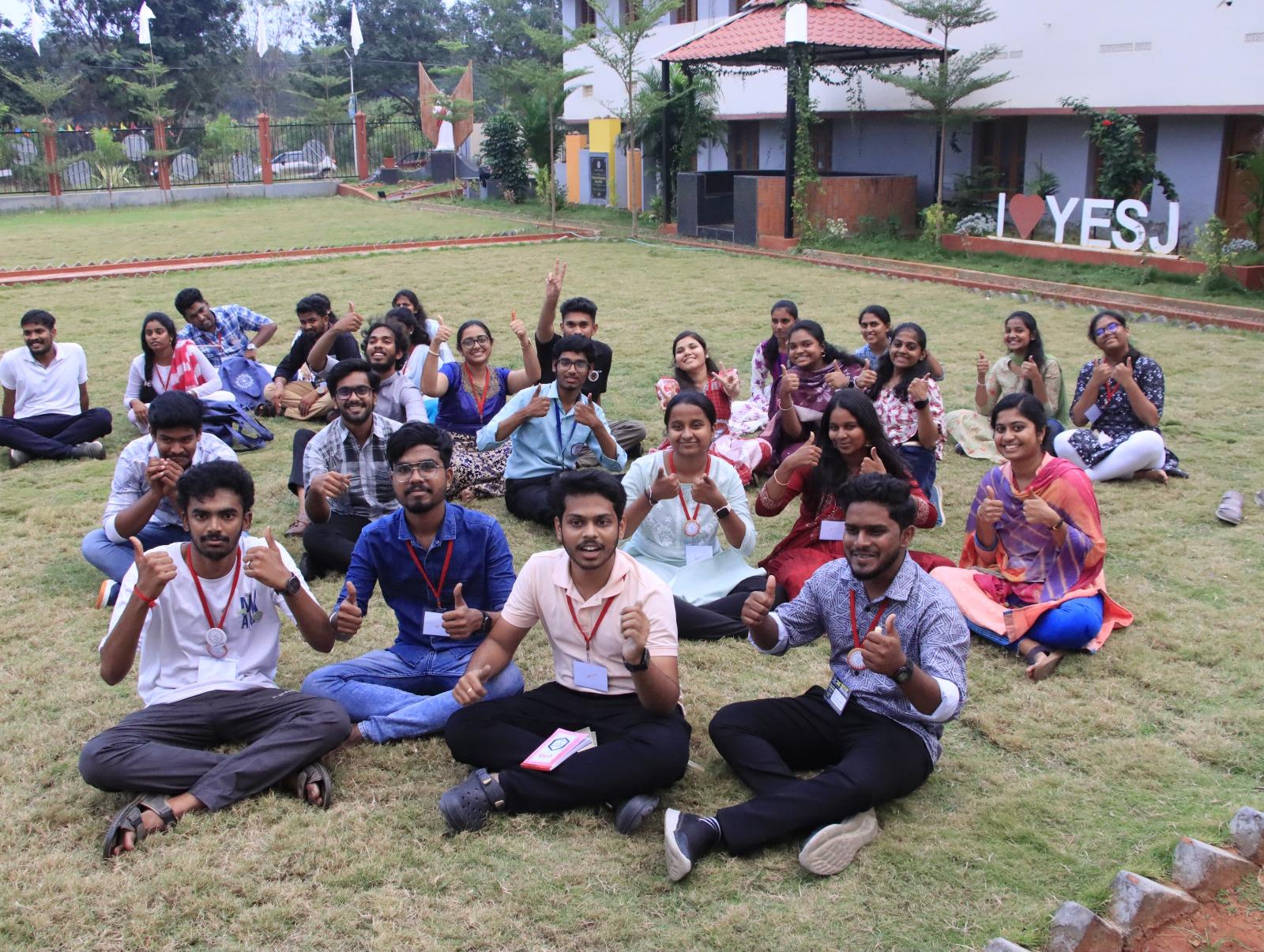 AICUF members at YESJ Centre giving thumbs up during a gathering